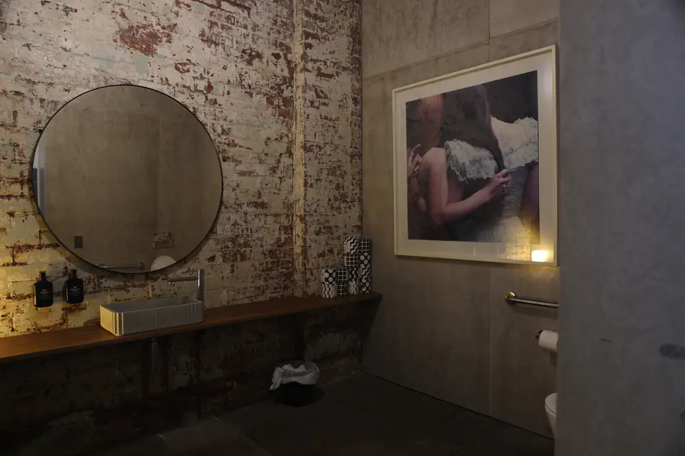 Basin and mirror against the brick