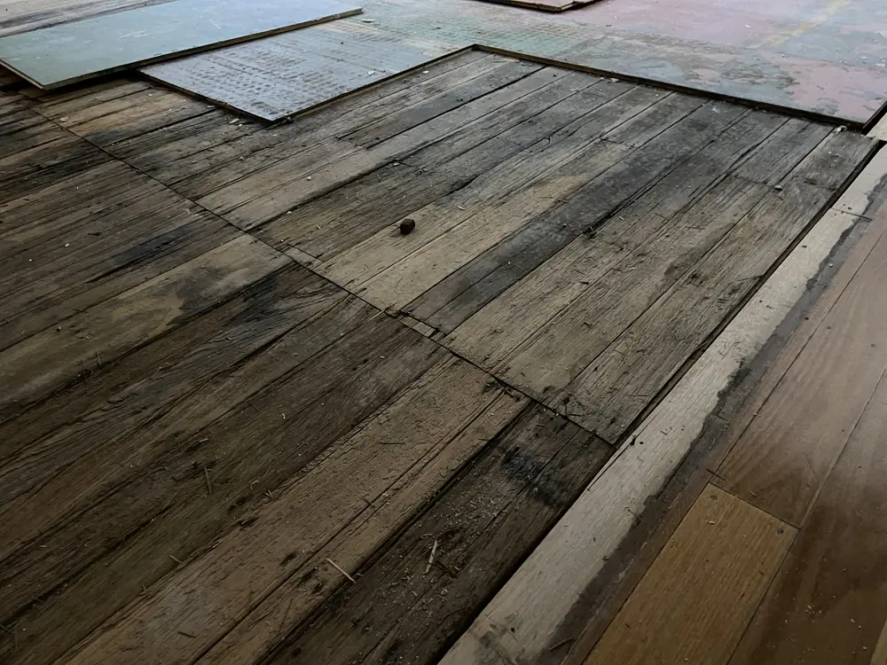 The old boards, rotted and patched
