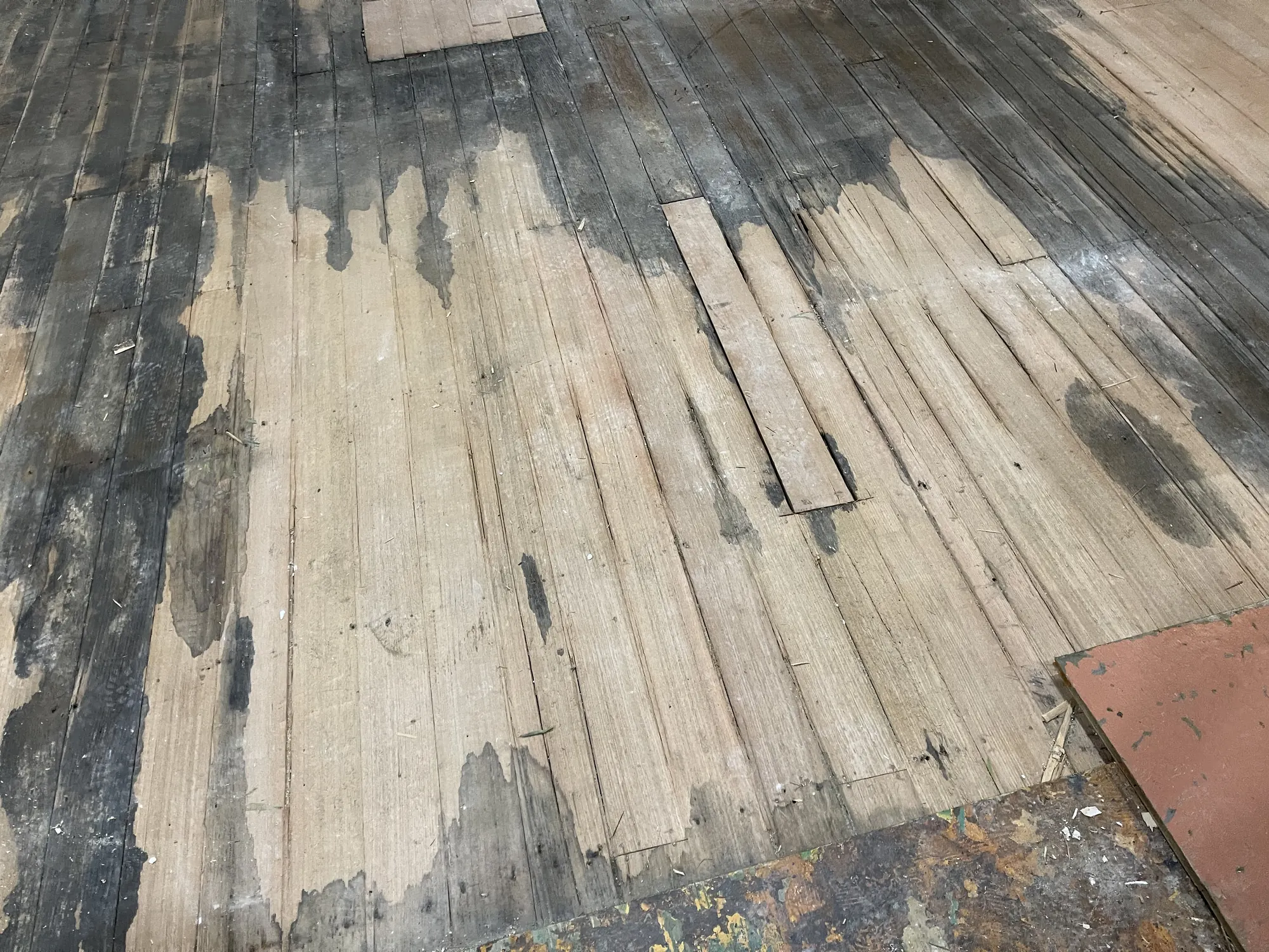 Rotted, water-stained boards once the old coverings came up, June 2021