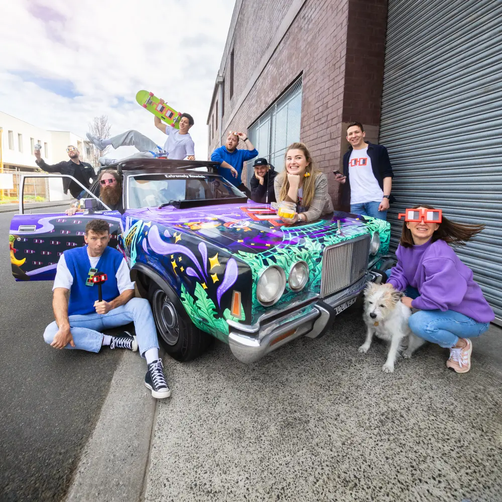 The team with the painted nouns art car at the roller door