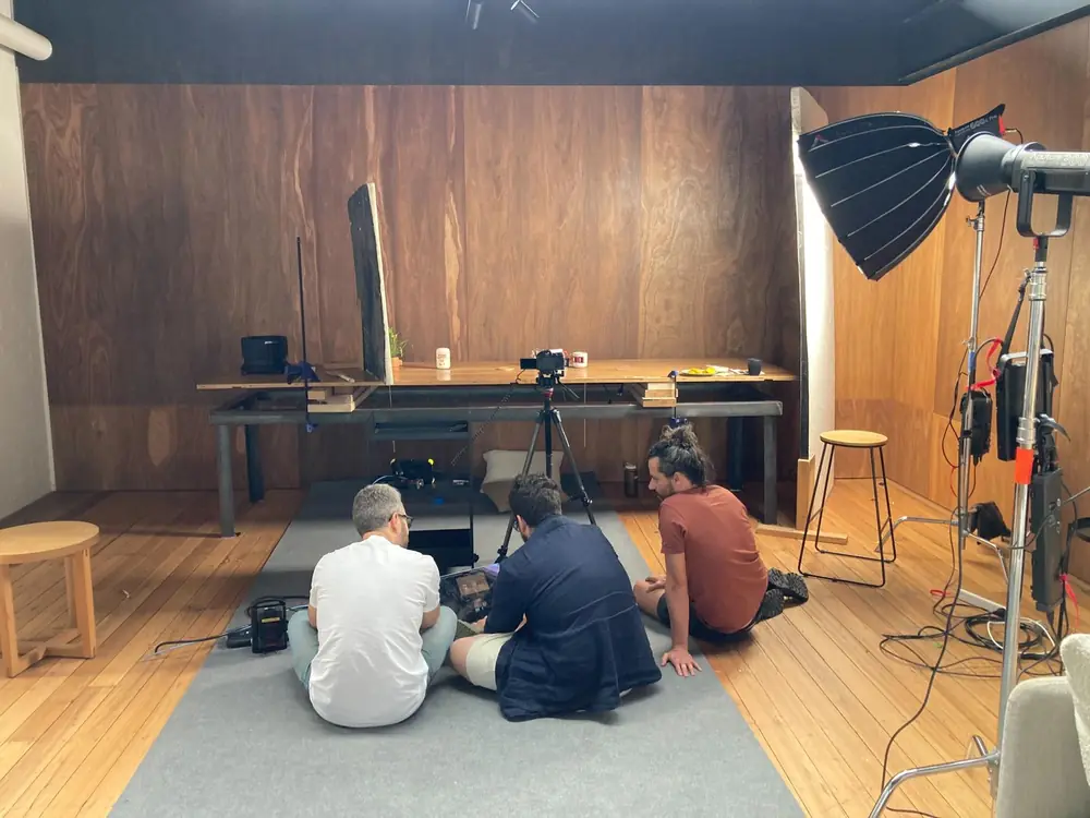 Crew on a shoot against the timber wall